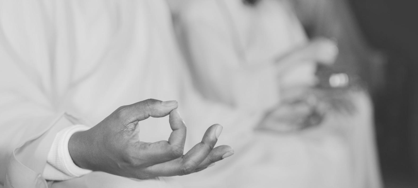 Person practicing mindful meditation in serene natural environment